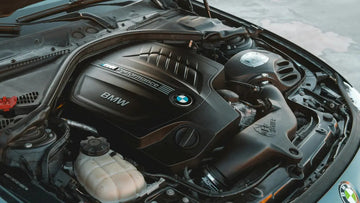 BMW engine bay with M Performance cover, car maintenance and automotive essentials