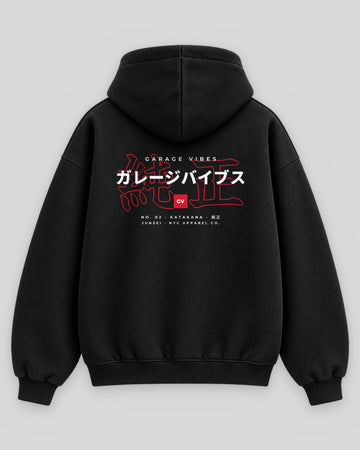 Back of the black Junsei No. 02 Katakana hoodie with ガレージバイブス katakana over a red 純正 outline and the GV badge